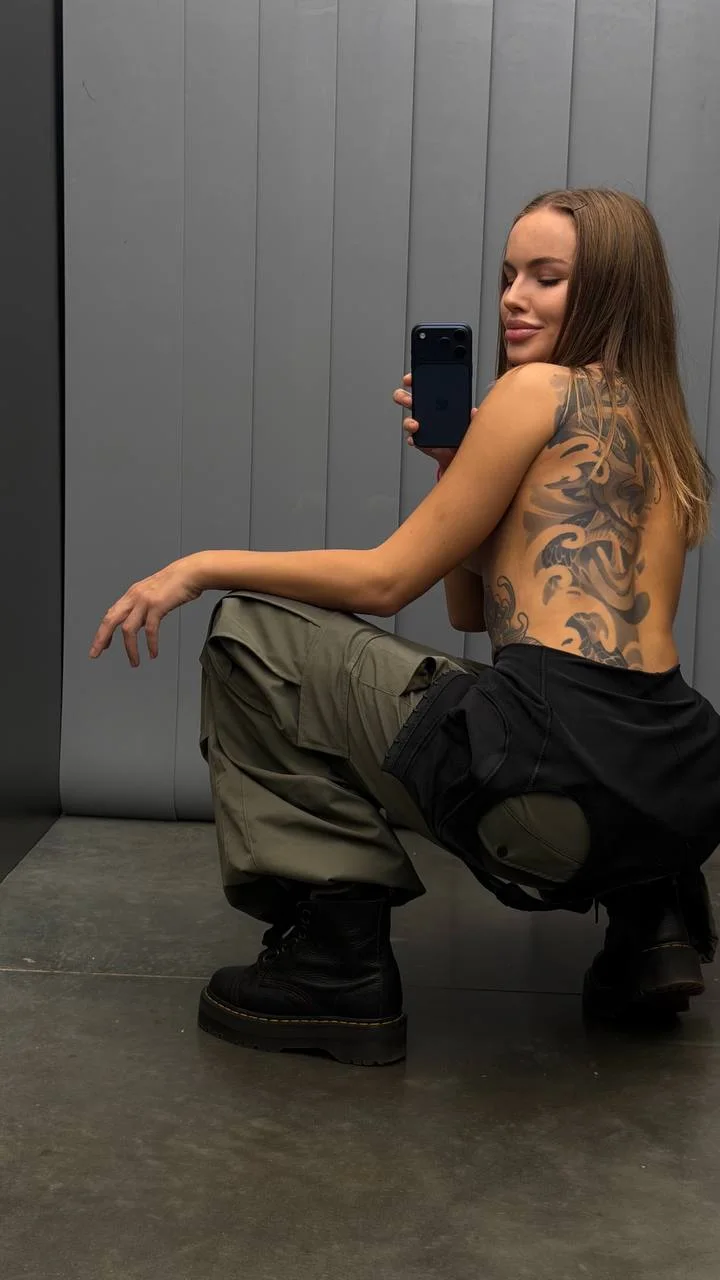 Casual mirror photo of Yana Chi in the studio corridor