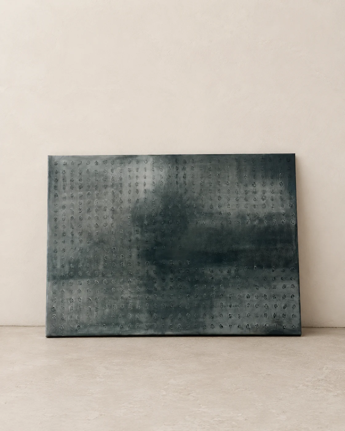 Detail of a graphite relief panel with fine punched texture