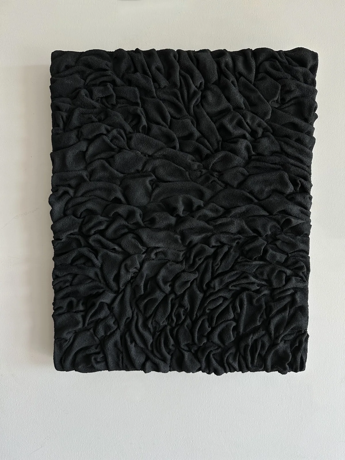 Detail of a black ruched relief surface
